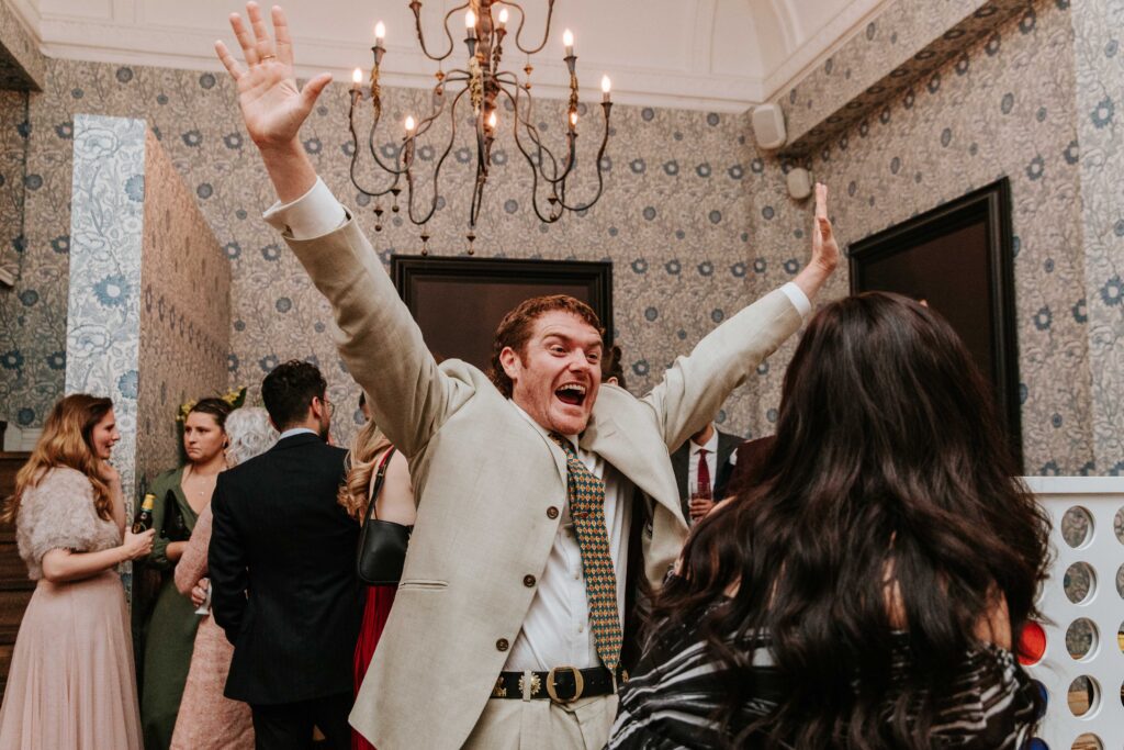 Man with arms in air bringing energy and excitement